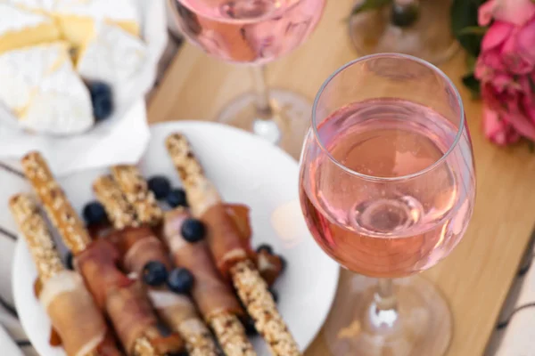 Ποτήρια Από Νόστιμο Ροζέ Κρασί Λουλούδια Και Φαγητό Ξύλινη Σανίδα — Φωτογραφία Αρχείου