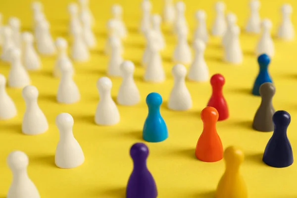 Colorful Pawns Yellow Background Closeup Social Inclusion Concept — Stock fotografie