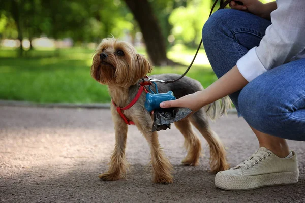 Woman Cute Dog Taking Waste Bag Holder Park Closeup — Stockfoto