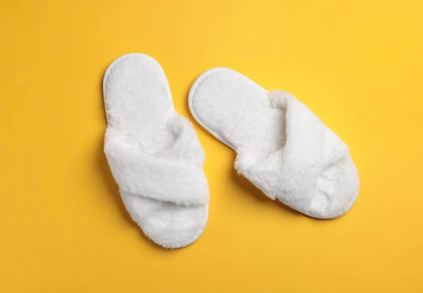 Pair Soft Fluffy Slippers Yellow Background Top View — Foto de Stock