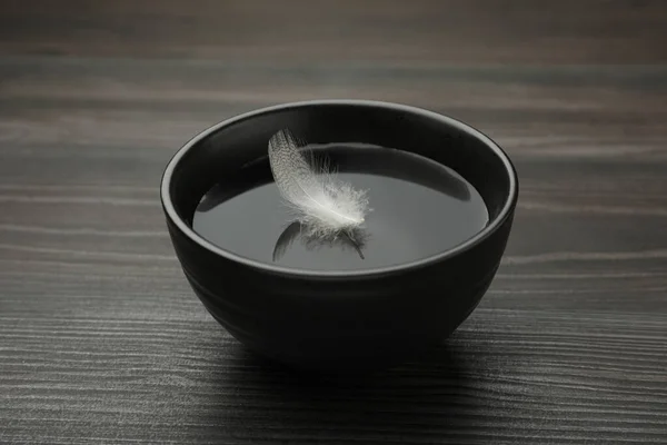 Black Bowl Water White Feather Dark Wooden Table — Foto Stock