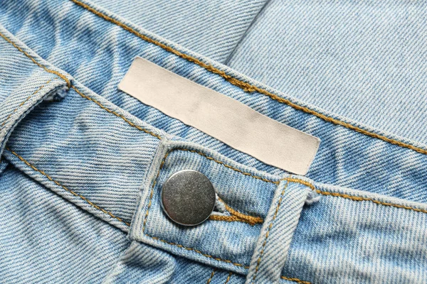 Etichetta Abbigliamento Bianca Jeans Azzurri Vista Dall Alto — Foto Stock