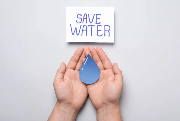 Man Holding Paper Drop Card Words Water Light Grey Background — Stock Photo, Image