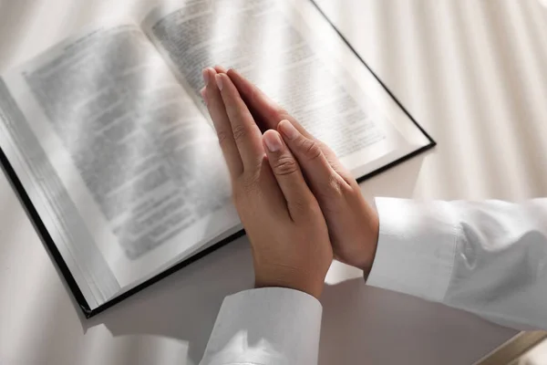 Donna Che Stringe Mano Mentre Prega Sulla Bibbia Tavola Bianca — Foto Stock