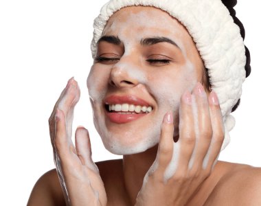 Beautiful woman applying facial cleansing foam on white background