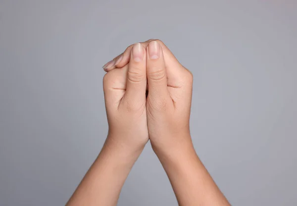 Woman Clasped Hands While Praying Light Grey Background Closeup — Stock Photo, Image