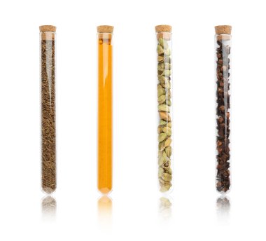 Beyaz zemin üzerinde farklı baharatlar bulunan cam tüpler.