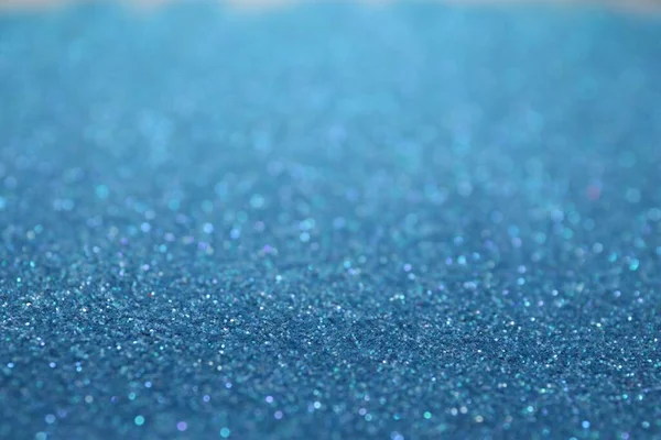 Shiny light blue glitter as background. Bokeh effect