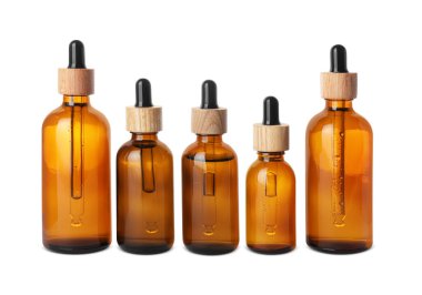 Row with different bottles of essential oil on white background