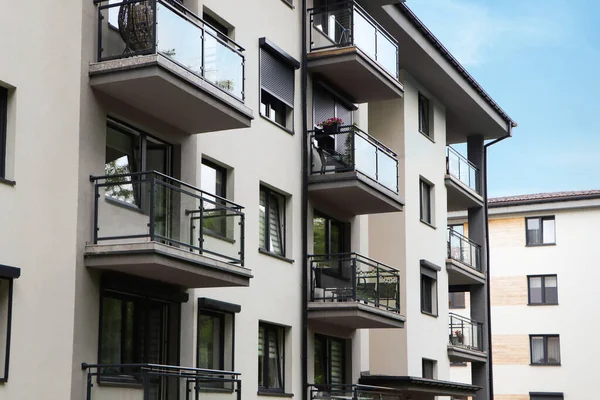 Exterior of white and black building with glass balconies