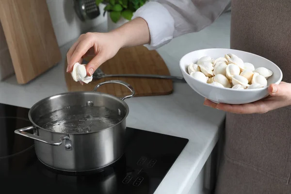 Woman Putting Frozen Dumplings Saucepan Boiling Water Cooktop Kitchen Closeup —  Fotos de Stock