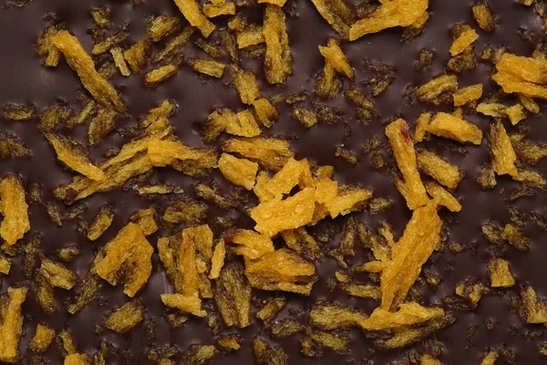 Chocolate bar with freeze dried fruits as background, closeup