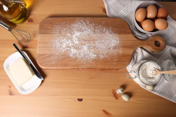 Many different ingredients for dough on wooden table, flat lay