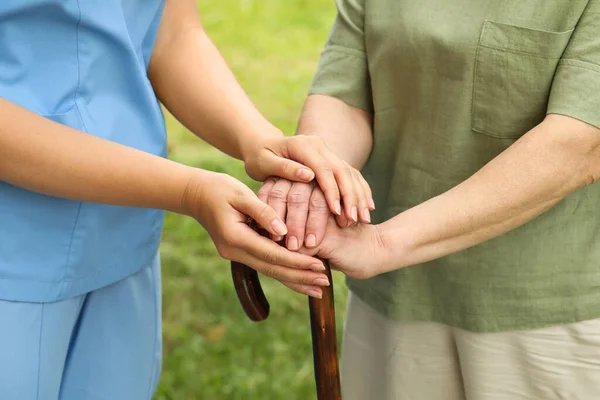 Elderly Woman Walking Cane Female Caregiver Outdoors Closeup — Foto Stock
