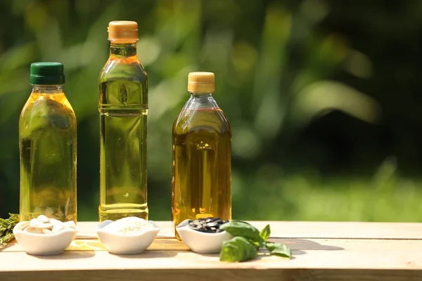 Different Cooking Oils Ingredients Wooden Table Blurred Green Background Space — Stock Photo, Image