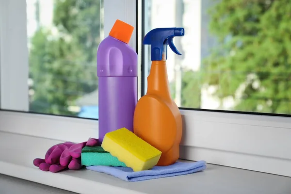 Cleaning supplies and tools on window sill indoors