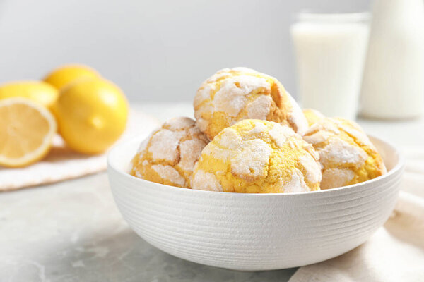 Delicious lemon cookies in bowl on grey table, closeup