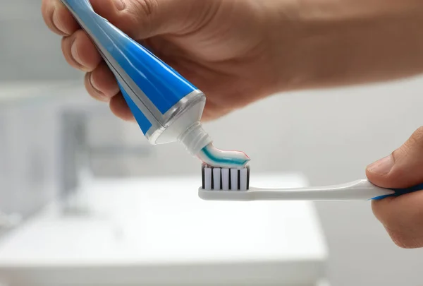 Man Applying Toothpaste Brush Bathroom Closeup — Stock Photo, Image