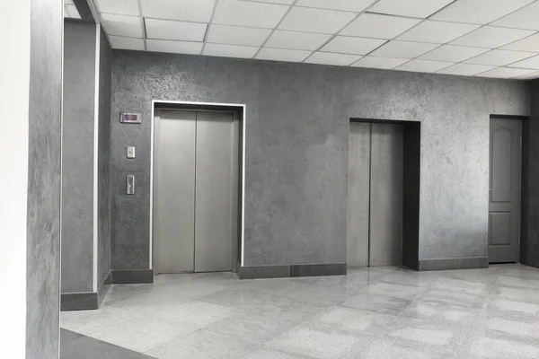 Closed stylish elevator doors in clean hall