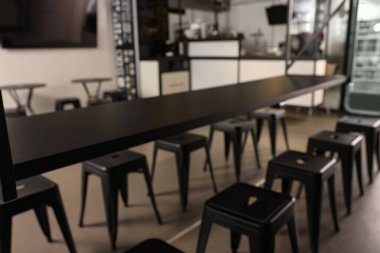 Blurred view of hostel dining room interior with comfortable furniture and coffee shop
