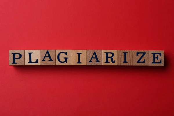 Wooden Cubes Word Plagiarism Red Background Flat Lay — Stock Photo, Image