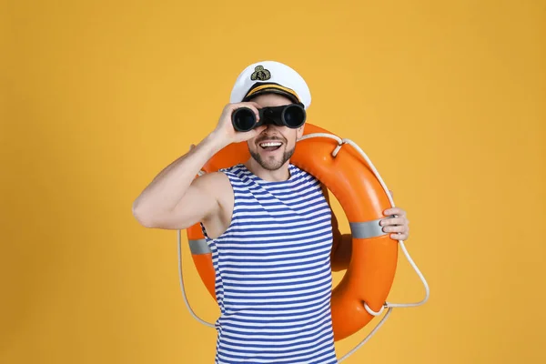 Sailor Orange Ring Buoy Looking Binoculars Yellow Background — Stock Photo, Image