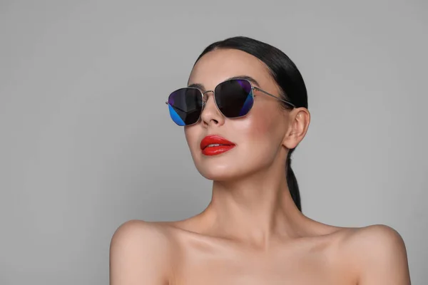 Atrakcyjna Kobieta Modnych Okularach Przeciwsłonecznych Szarym Tle Miejsce Tekst — Zdjęcie stockowe
