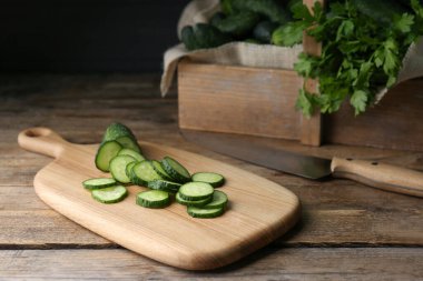 Slices of fresh ripe cucumber on wooden table