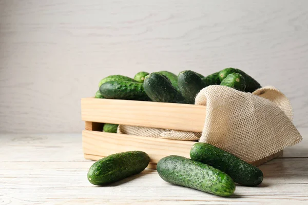 Crate Full Fresh Ripe Cucumbers White Wooden Table — ストック写真