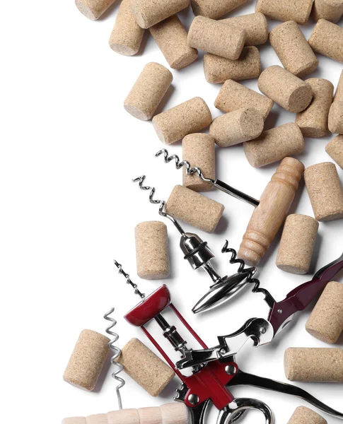 Different corkscrews and wine bottle stoppers on white background, top view