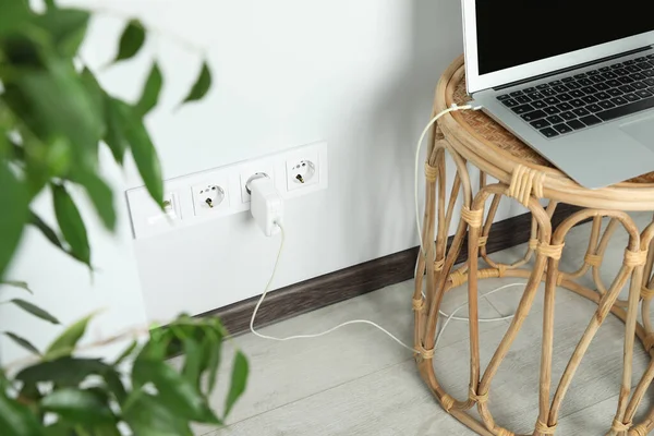 Electric power outlet sockets with charger on white wall