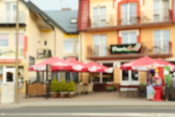 Blurred view of outdoor cafe with umbrellas