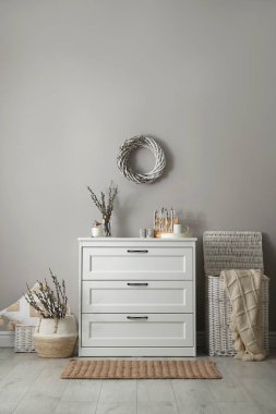 Room interior with pussy willow branches and other decor