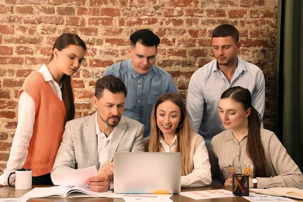 Team of employees working together in office