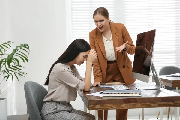 Boss screaming at employee in office. Toxic work environment