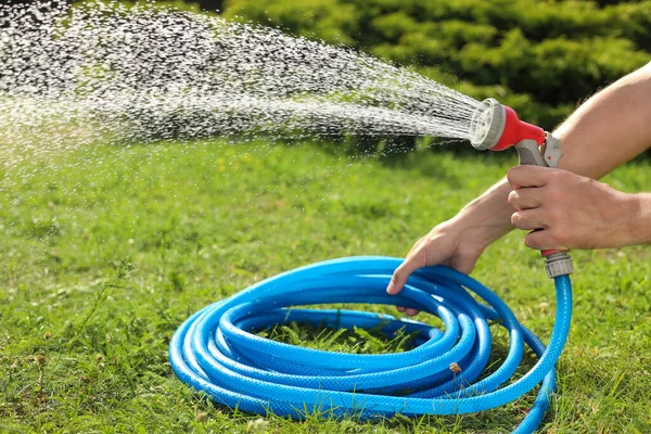 Man Watering Green Grass Garden Closeup — Stockfoto