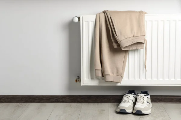 Heating Radiator Beige Pants Sneakers Indoors Space Text — Stock Photo, Image