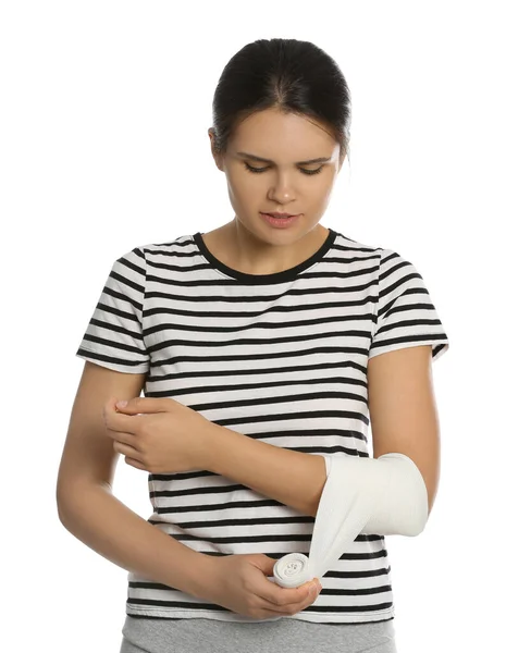 Young Woman Applying Medical Bandage Arm White Background — Stock Photo, Image
