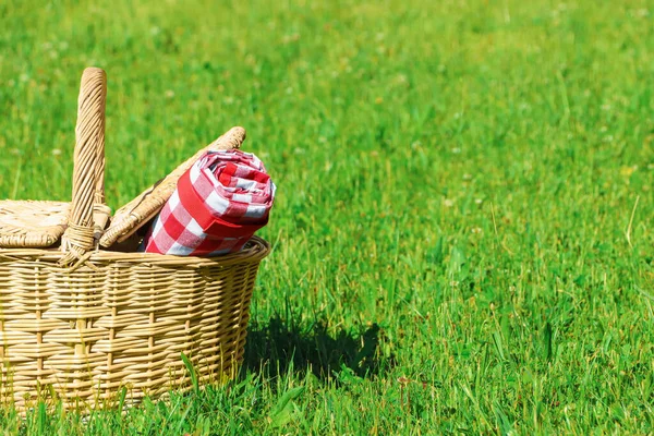 Rolled Checkered Tablecloth Picnic Basket Green Grass Outdoors Space Text — Φωτογραφία Αρχείου