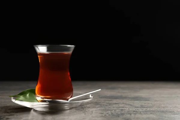 Szkło Tradycyjną Turecką Herbatą Szarym Stole Czarnym Tle Miejsce Tekst — Zdjęcie stockowe