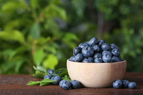 Tasty Fresh Blueberries Green Leaves Wooden Table Outdoors Space Text — Stockfoto