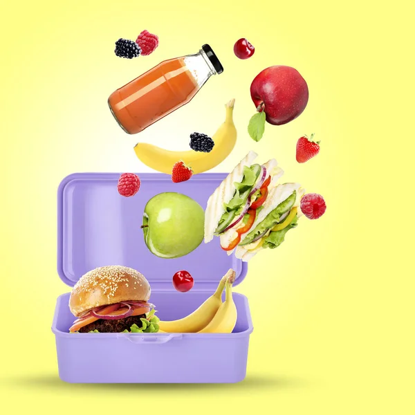 Different fresh food falling into lunch box on yellow background. School meal