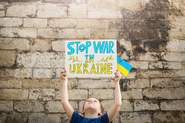 Boy Holding Poster Stop War Ukraine National Flag Brick Wall — Stock fotografie