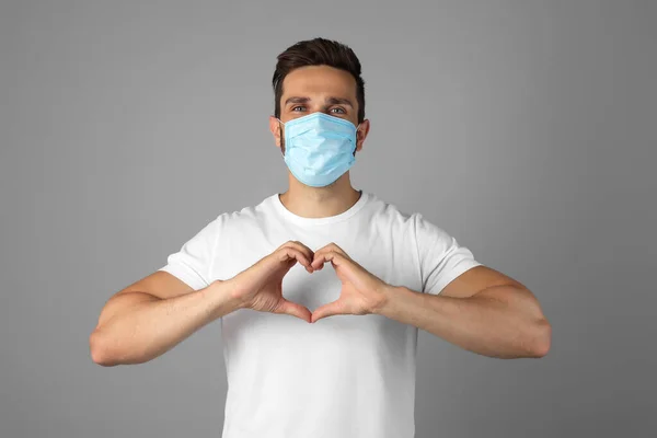 Man Protective Mask Making Heart Hands Grey Background — Stock Photo, Image