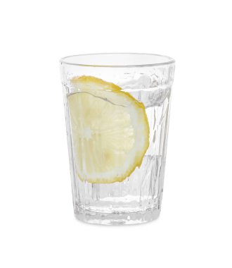 Water with sliced lemon splashing out of glass on white background