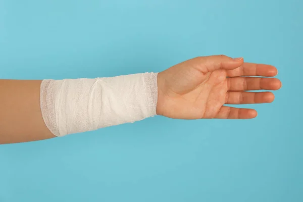 Woman Wrist Wrapped Medical Bandage Light Blue Background Closeup — Stock Photo, Image