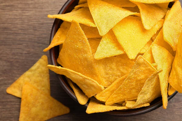 Tortilla chips (nachos) on wooden table, flat lay