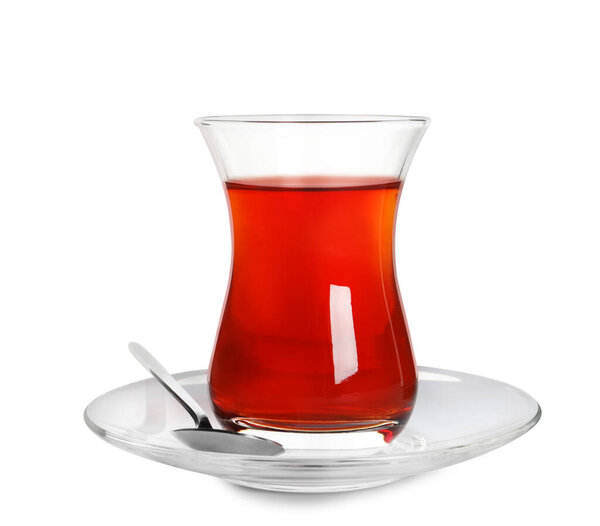 Glass of traditional Turkish tea with spoon isolated on white