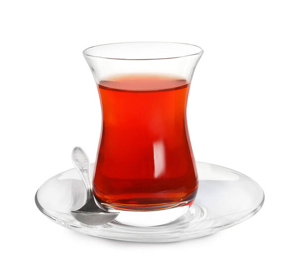 Glass of traditional Turkish tea with spoon isolated on white