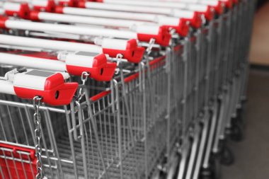 Süpermarketin yakınında bir sürü boş metal alışveriş arabası var. Metin için boşluk